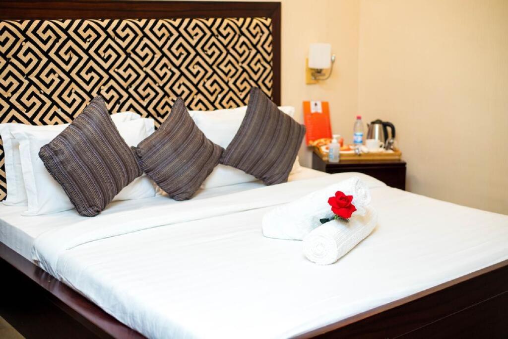 Postel nebo postele na pokoji v ubytování Hôtel Guest House Quatre Saisons