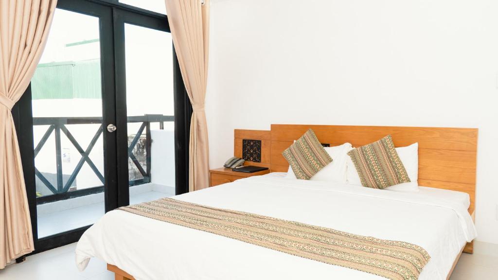 Postel nebo postele na pokoji v ubytování Trung Nguyên Coffee Resort