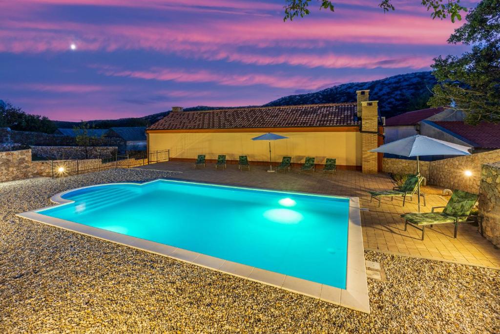 a swimming pool in front of a house at Villa Eirene in Drivenik