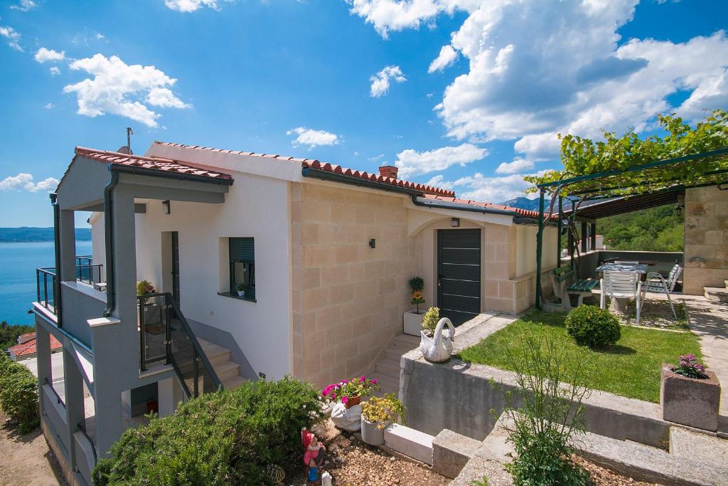 uma pequena casa com vista para a água em Apartments Vila Nadalina Delux em Brela