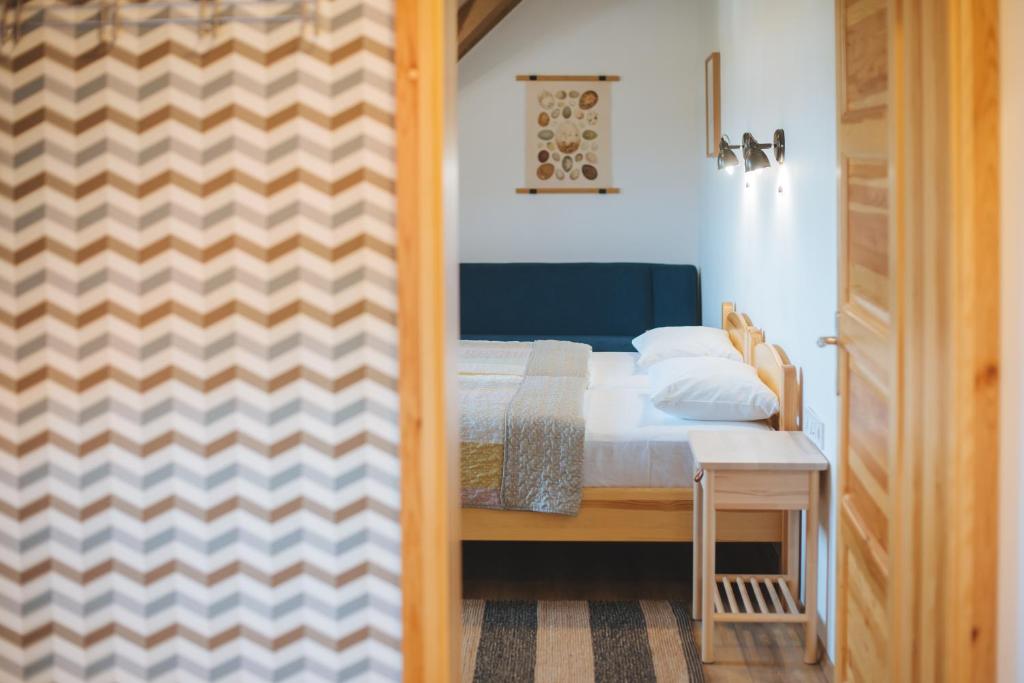 A bed or beds in a room at Kormorán panzió