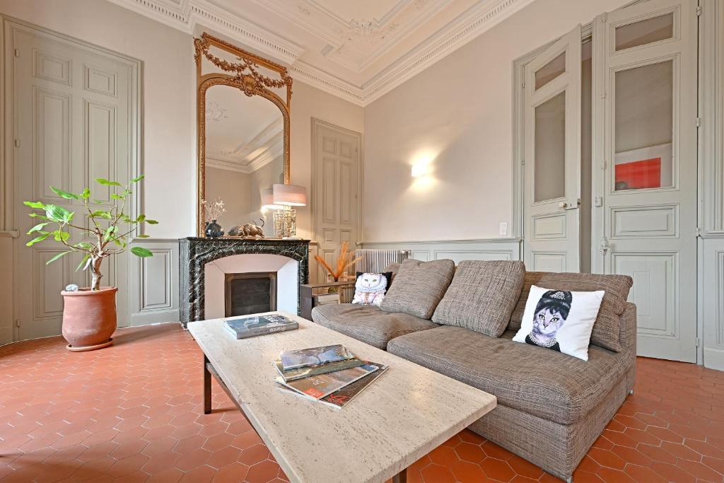 a living room with a couch and a fireplace at Le Vieux Sextier - AC Clim - Lumineux - WIFI - Hypercentre in Avignon