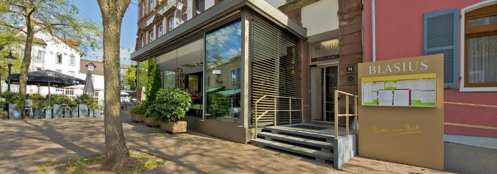 a store with a sign in front of a building at Ratsstube Blasius in Merzig