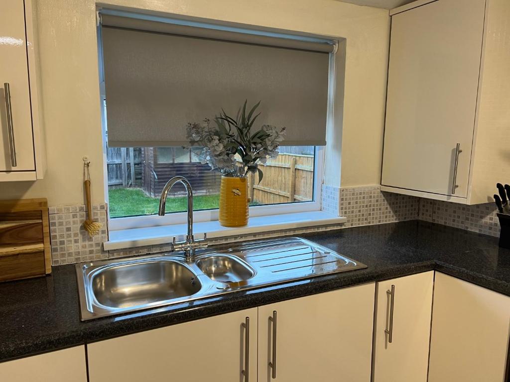 a kitchen with a sink and a window at Honeybee House in Redcar