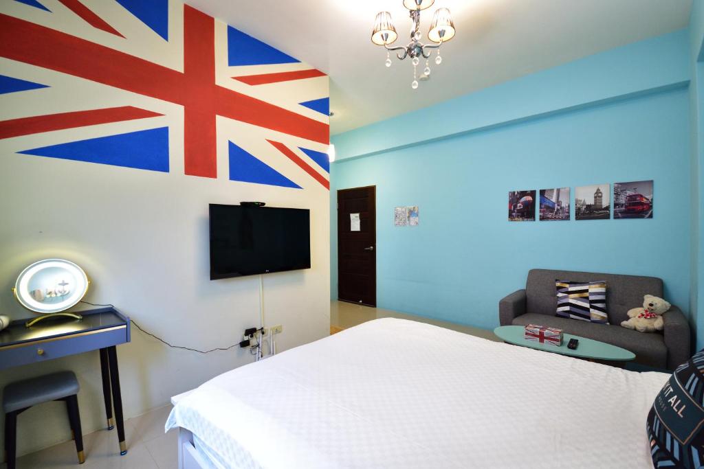 a bedroom with a bed and a flag on the wall at Piau Po 21 Inn in Taitung City