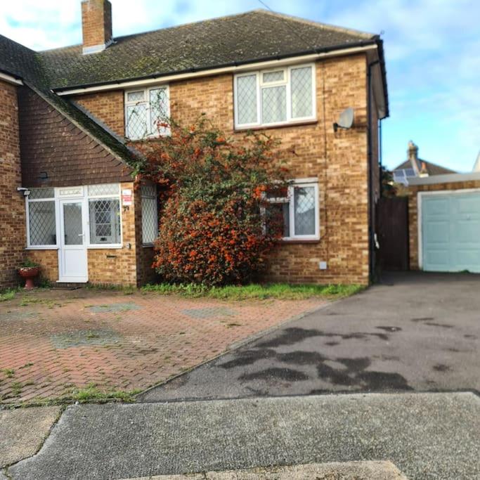 a brick house with a driveway and a garage at Lovely Home away from home! in Bexleyheath