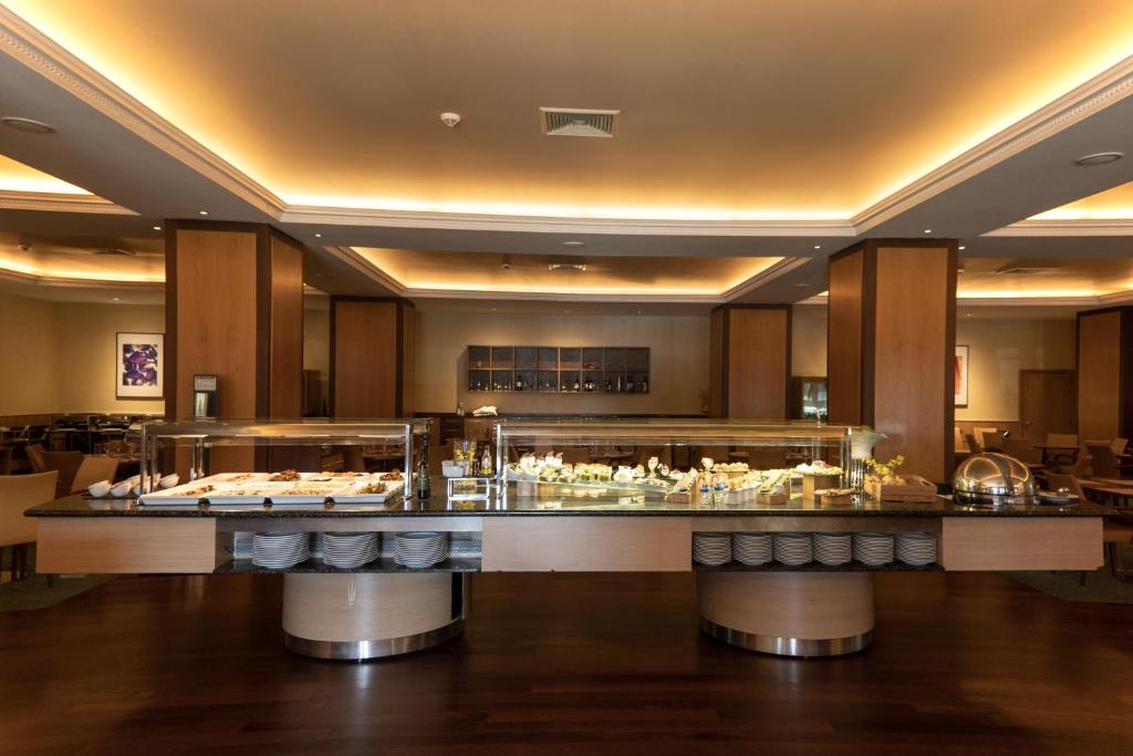 A broad buffet counter displays prepared foods in a formal dining room.