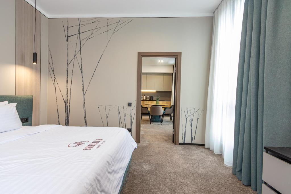 Postel nebo postele na pokoji v ubytování Shelter Apart Hotel