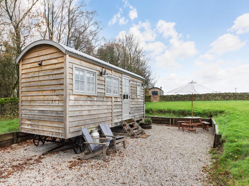 a wooden tiny house with a table and chairs at The Swaledale Hut - Uk40151 in Rathmell