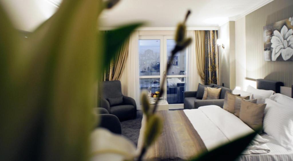 a living room with a couch and a large window at Koza Suite Hotel in Ankara