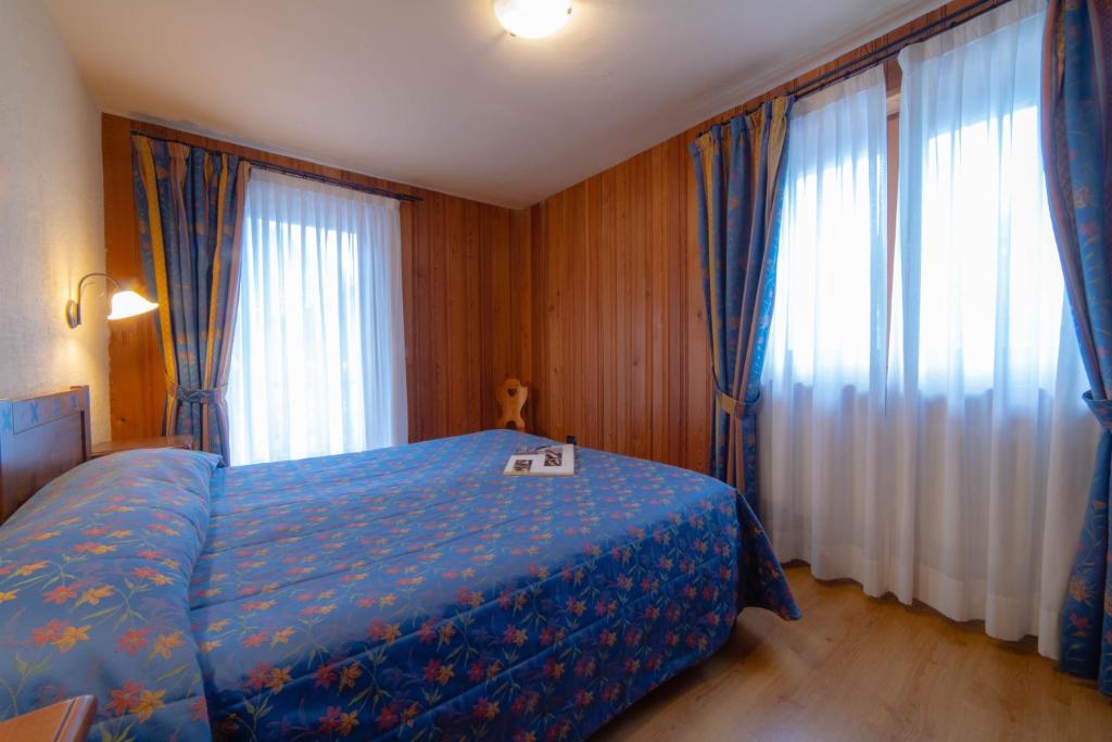 Postel nebo postele na pokoji v ubytování Family Apartments Le Chalet
