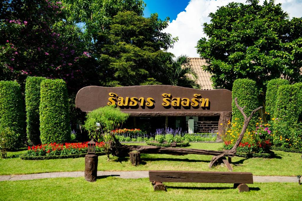 a sign for a saissos sushi restaurant in a park at Rimtarn Resort in Mae Hong Son