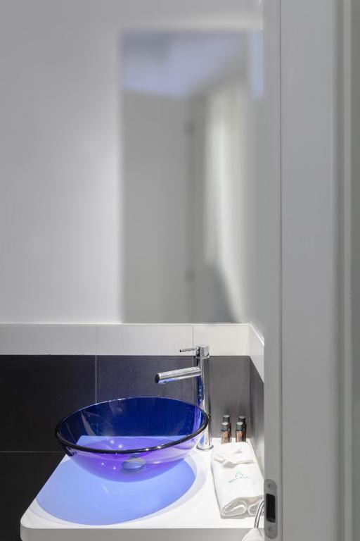 a blue bowl sitting on top of a sink at Relais Roma Centro in Rome