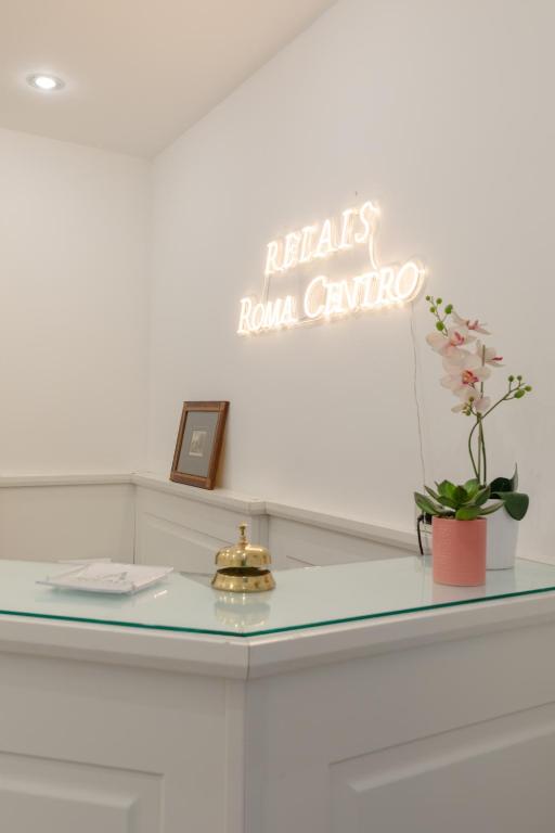 a glass counter with a sign that reads hello room guru at Relais Roma Centro in Rome