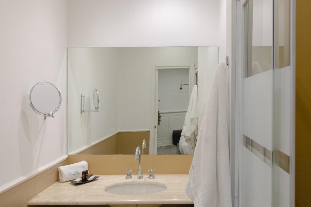 a bathroom with a sink and a mirror at Relais Roma Centro in Rome