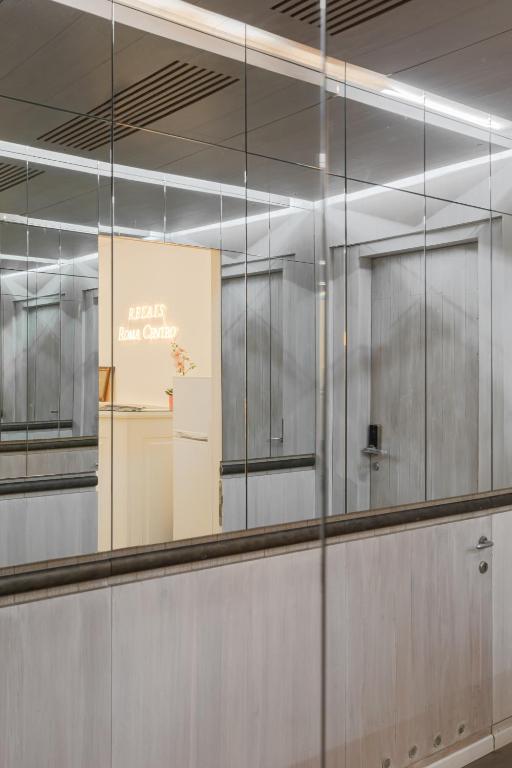 a glass wall in a building with a sign on it at Relais Roma Centro in Rome