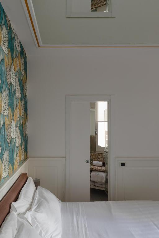 a bedroom with a bed and a painting on the wall at Relais Roma Centro in Rome
