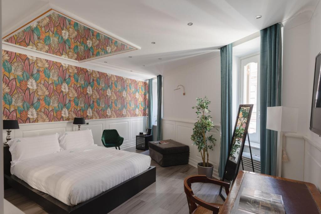 a bedroom with a bed and a tapestry on the wall at Relais Roma Centro in Rome
