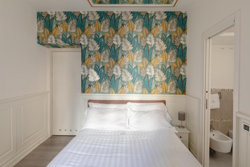 a bedroom with a bed with a floral wallpaper at Relais Roma Centro in Rome