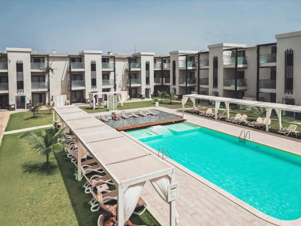 an image of a swimming pool at a apartment complex at Halos Casa Resort in Santa Maria