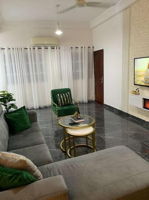 a living room with a couch and a table at Superbe appartement cosy-chic in Cotonou