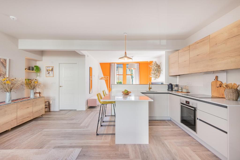 a kitchen with white counters and wooden cabinets at Esperance - Brand New, luxury studio with parking in Bowness-on-Windermere