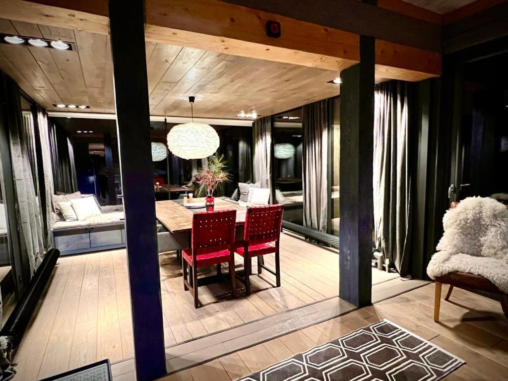 a dining room and living room with a table and chairs at Chalet Donky in Donovaly