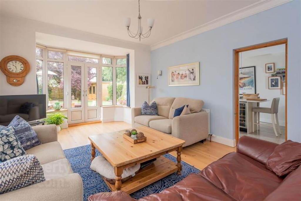 a living room with a couch and a table at Delightful Family Home in Lisburn