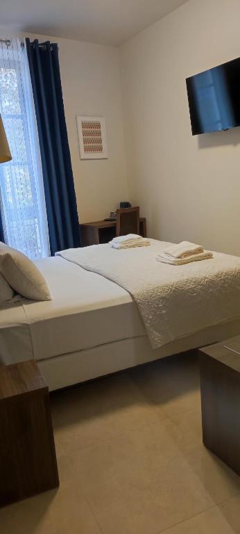 Postel nebo postele na pokoji v ubytování SQUARE HOTEL