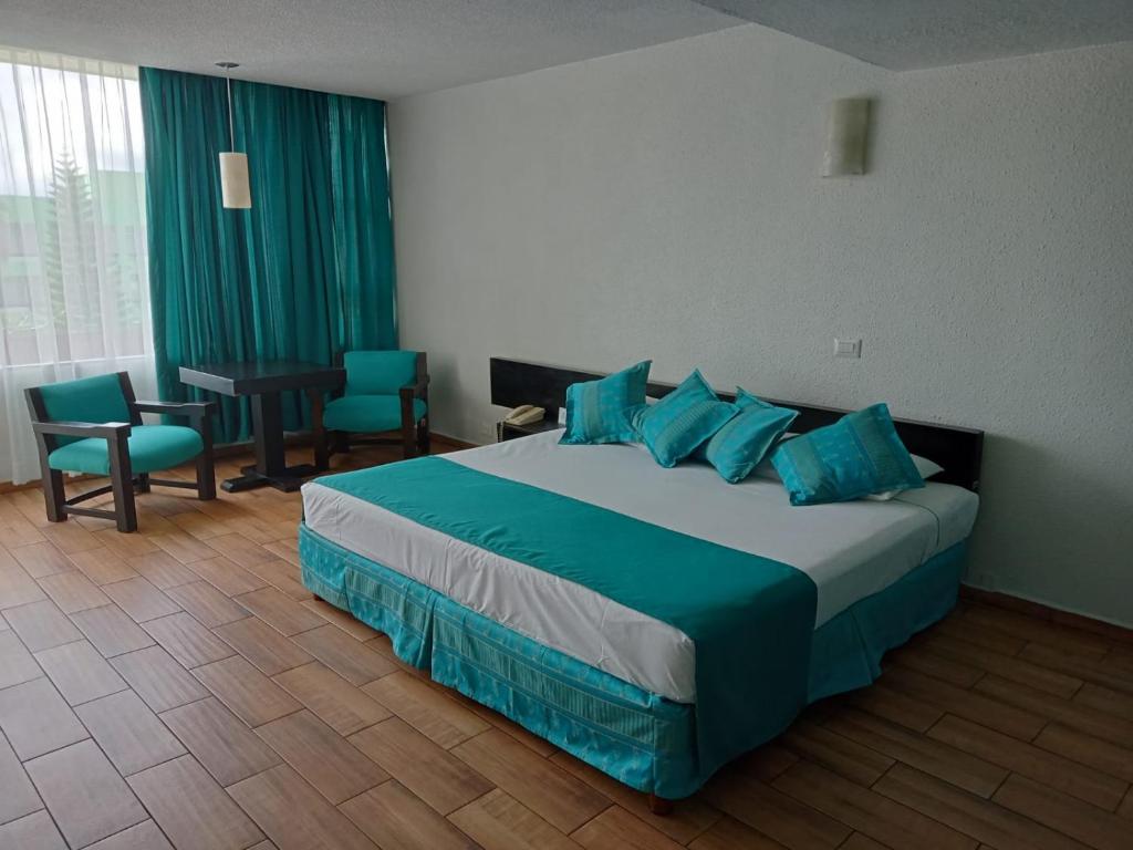 Postel nebo postele na pokoji v ubytování Gran Hotel Xalapa