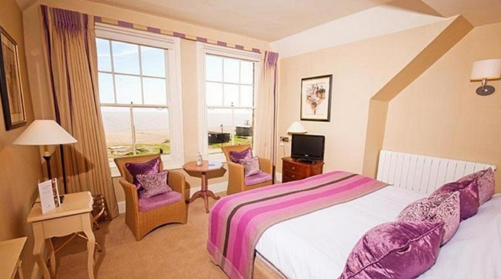 a hotel room with a bed and a window at Wentworth Hotel in Aldeburgh