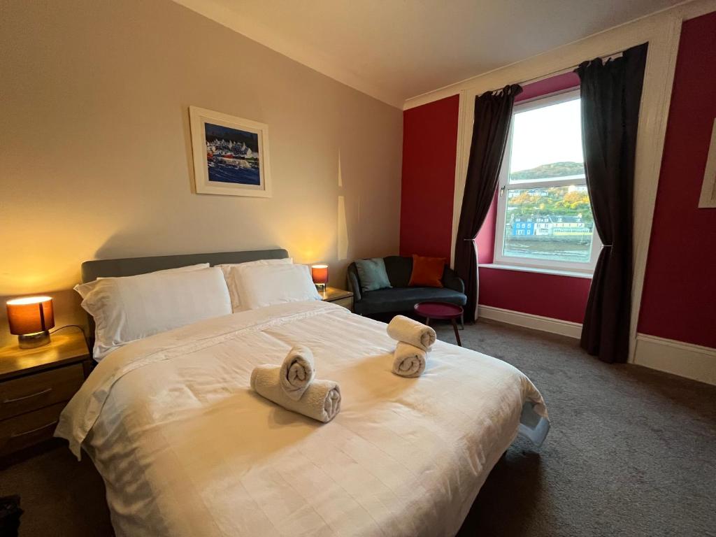 a hotel room with a bed with towels on it at The waterfront in Tarbert