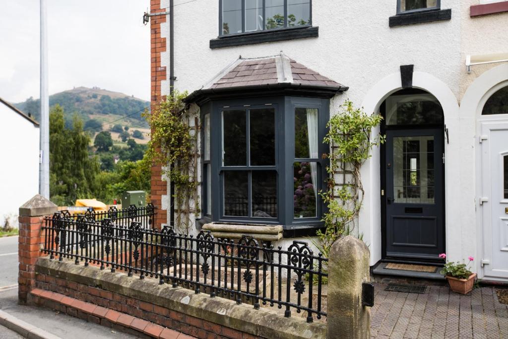 a house with a black door and a fence at 1 Bodwen Villas in Llangollen