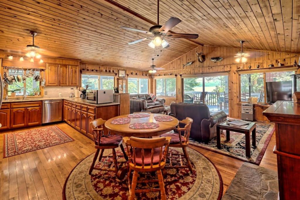 a kitchen and living room with a table and chairs at Hannahs Perch on Lake Burton with Private Top Patio and Bottom Dock in Clayton