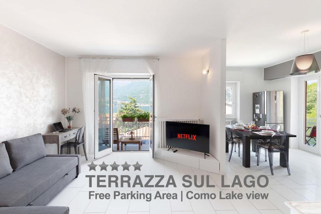 a living room with a couch and a fireplace at TERRAZZA SUL LAGO - Open Space e Netflix in Lecco