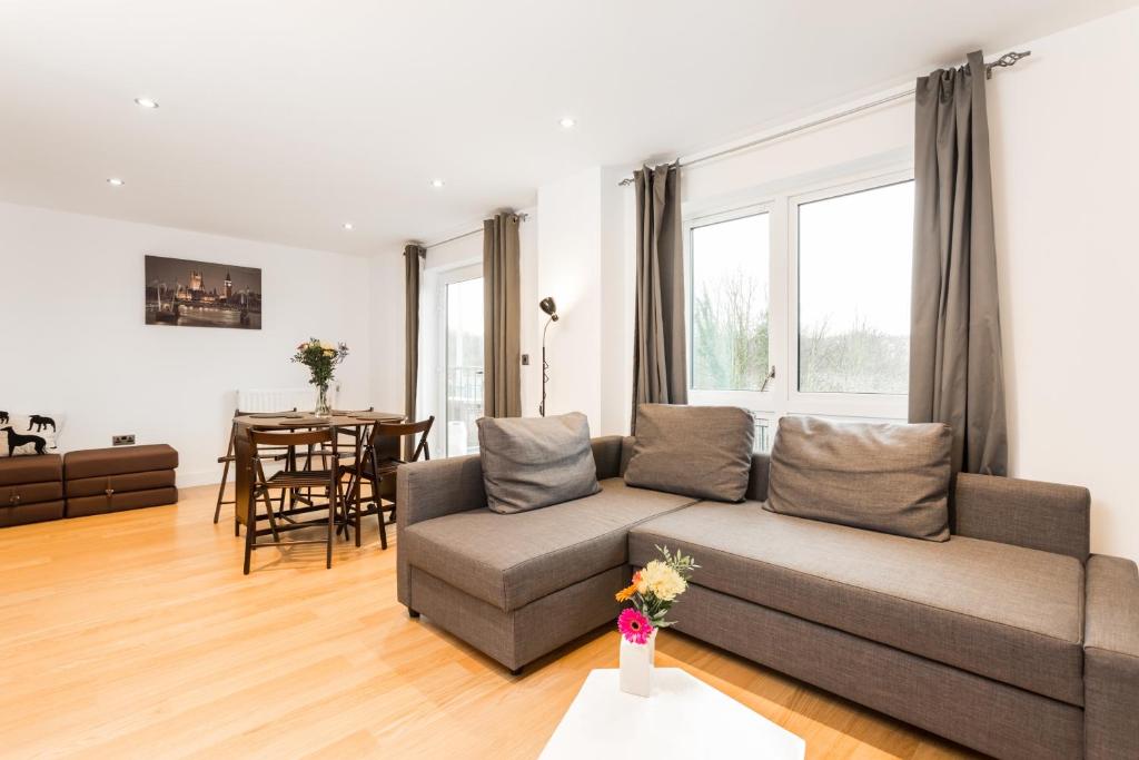 a living room with a couch and a table at ALTIDO Lovely 1-Bed Flat near 02 Arena in London