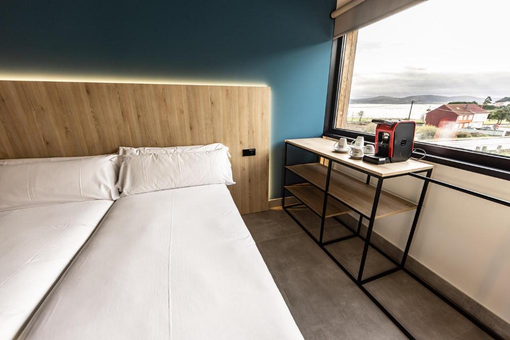 Postel nebo postele na pokoji v ubytování Hospedium Hotel Devalar Do Mar