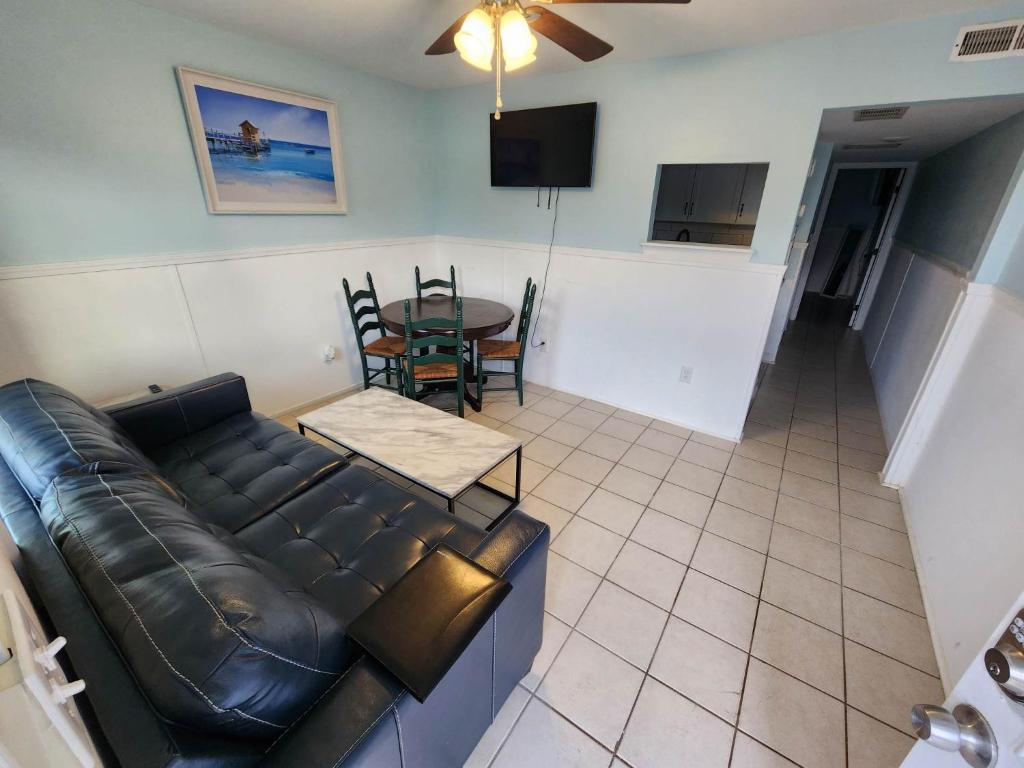 a living room with a couch and a table at 125 Atlantic Avenue Unit E - Pet Friendly! Walk To The Beach and Pier!1BR -1BA - Sleeps 2-4 guests! in Myrtle Beach
