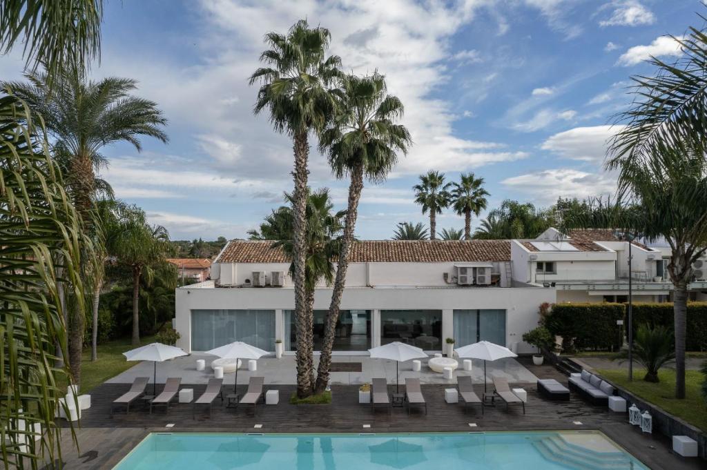einen Luftblick auf ein Resort mit einem Pool und Palmen in der Unterkunft Villa Carlino House in Mascali