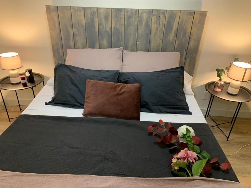 a bedroom with a large bed with two tables at Bonito piso cerca de Ventas, Madrid in Madrid