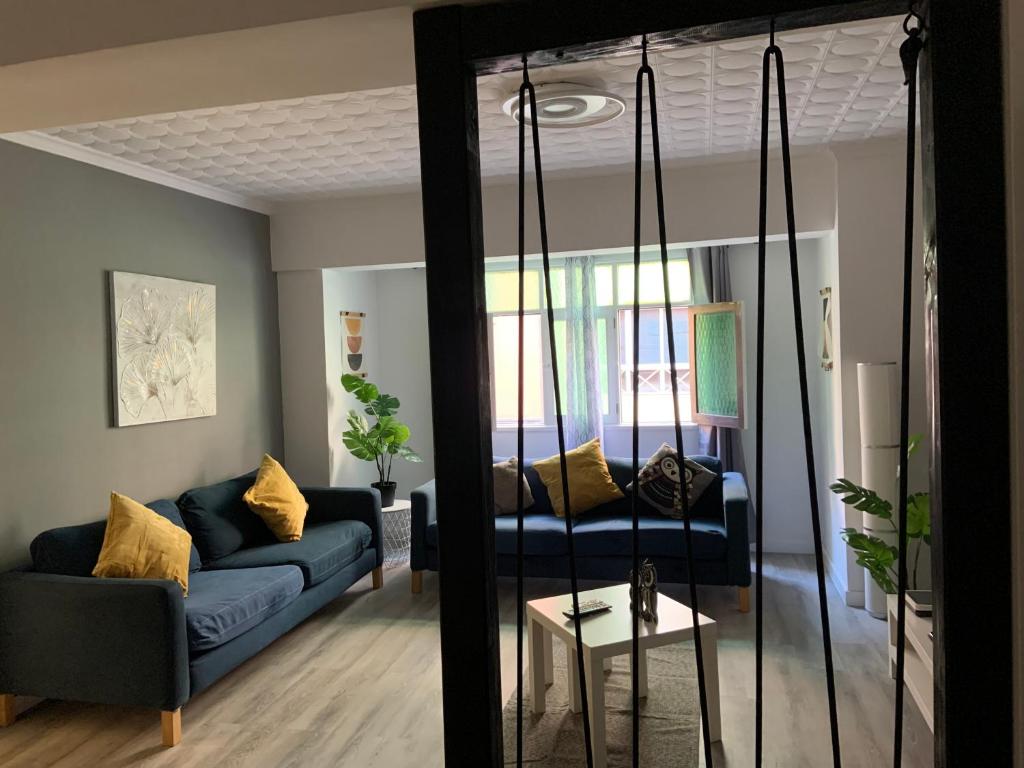 a living room with a blue couch and a mirror at CoLiving El Toro in Las Palmas de Gran Canaria