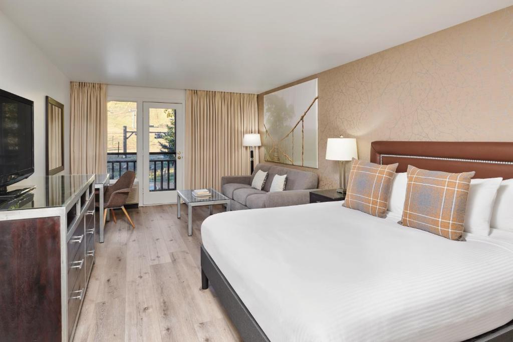 a hotel room with a large bed and a television at The Inn at Aspen in Aspen