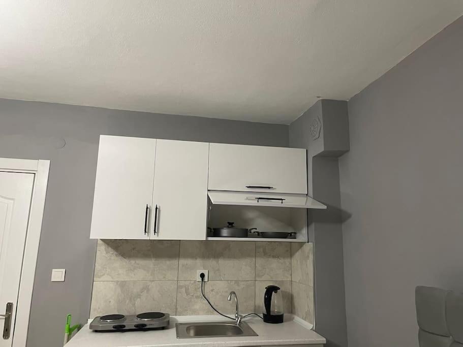 a kitchen with white cabinets and a sink at Ti6 in Istanbul