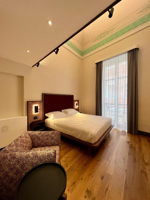 Postel nebo postele na pokoji v ubytování Lo Stemma Luxury Boutique Hotel