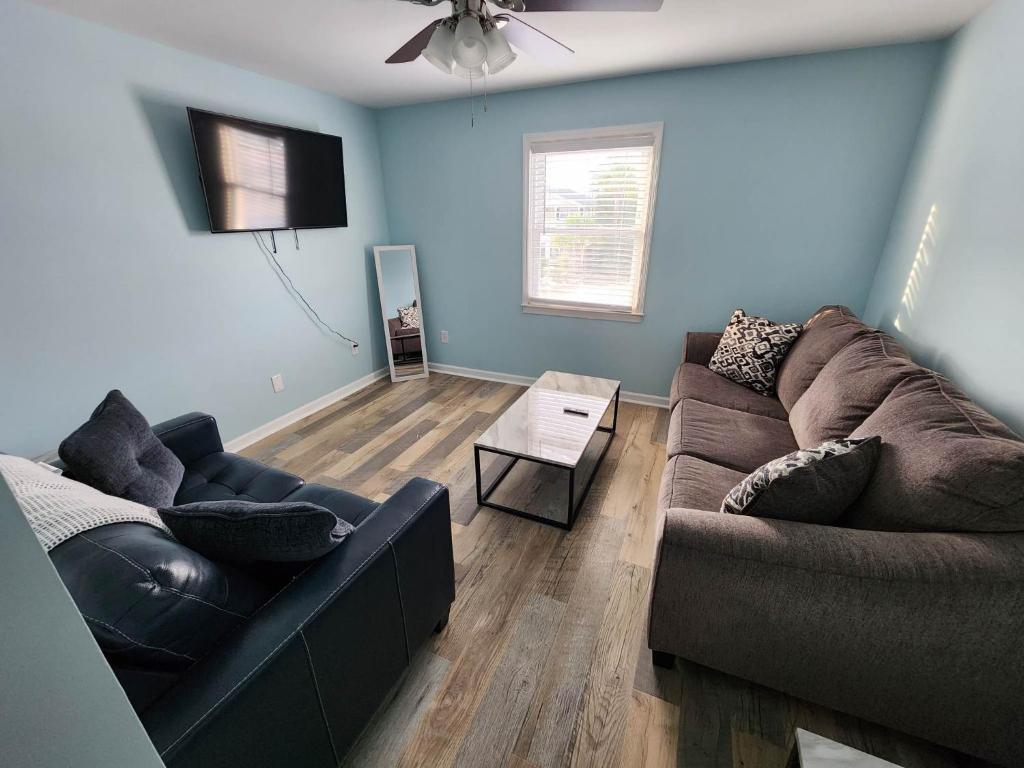a living room with two couches and a ceiling fan at 125 Atlantic Avenue Unit H - Pet Friendly! Walk To The Beach and Pier!1BR -1BA - Sleeps 4 guests! in Myrtle Beach