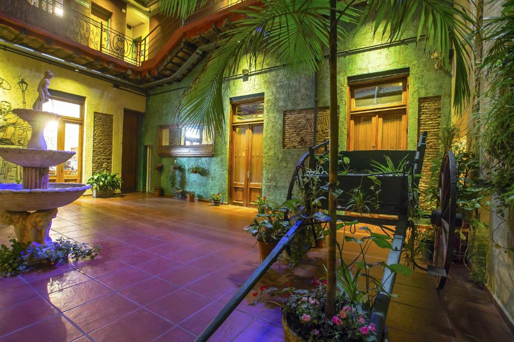 un vestíbulo con una fuente y plantas en un edificio en Hotel Parada en Buenos Aires