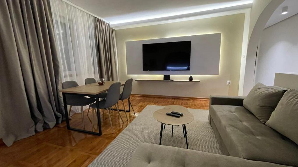 a living room with a couch and a table at Filip Luxury Suite in Belgrade