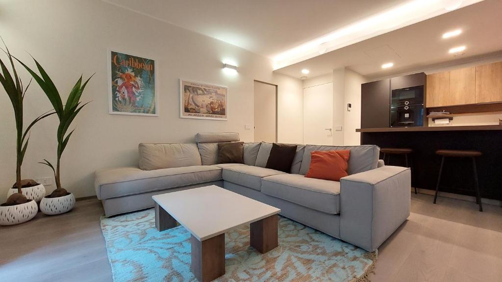 a living room with a couch and a table at Cressoni Apartment in Como