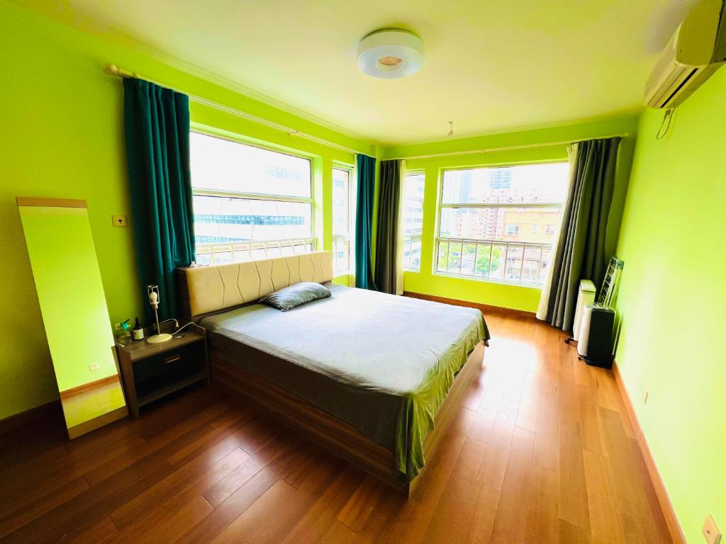 a bedroom with a bed and two windows at Top floor sunny bedroom near Fudan in Shanghai