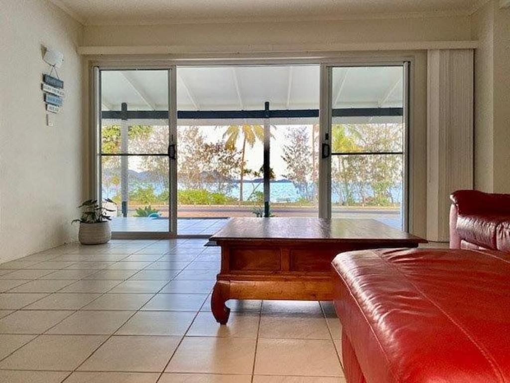 a living room with a couch and a large window at Beach Haven in Mission Beach